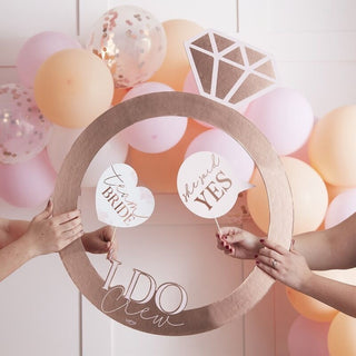 Rose gold ring-shaped photo booth frame with â€œI Do Crewâ€ text, measuring 74cm x 59cm, ideal for hen party photos.
