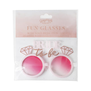 Blush pink sunglasses with rose gold 'Bride To Be' lettering and diamond accents, ideal for hen party celebrations.