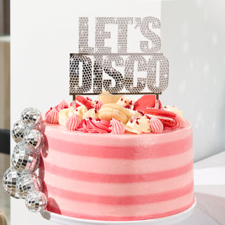 Silver acrylic 'Let's Disco' cake topper, ideal for disco-themed celebrations and hen parties.